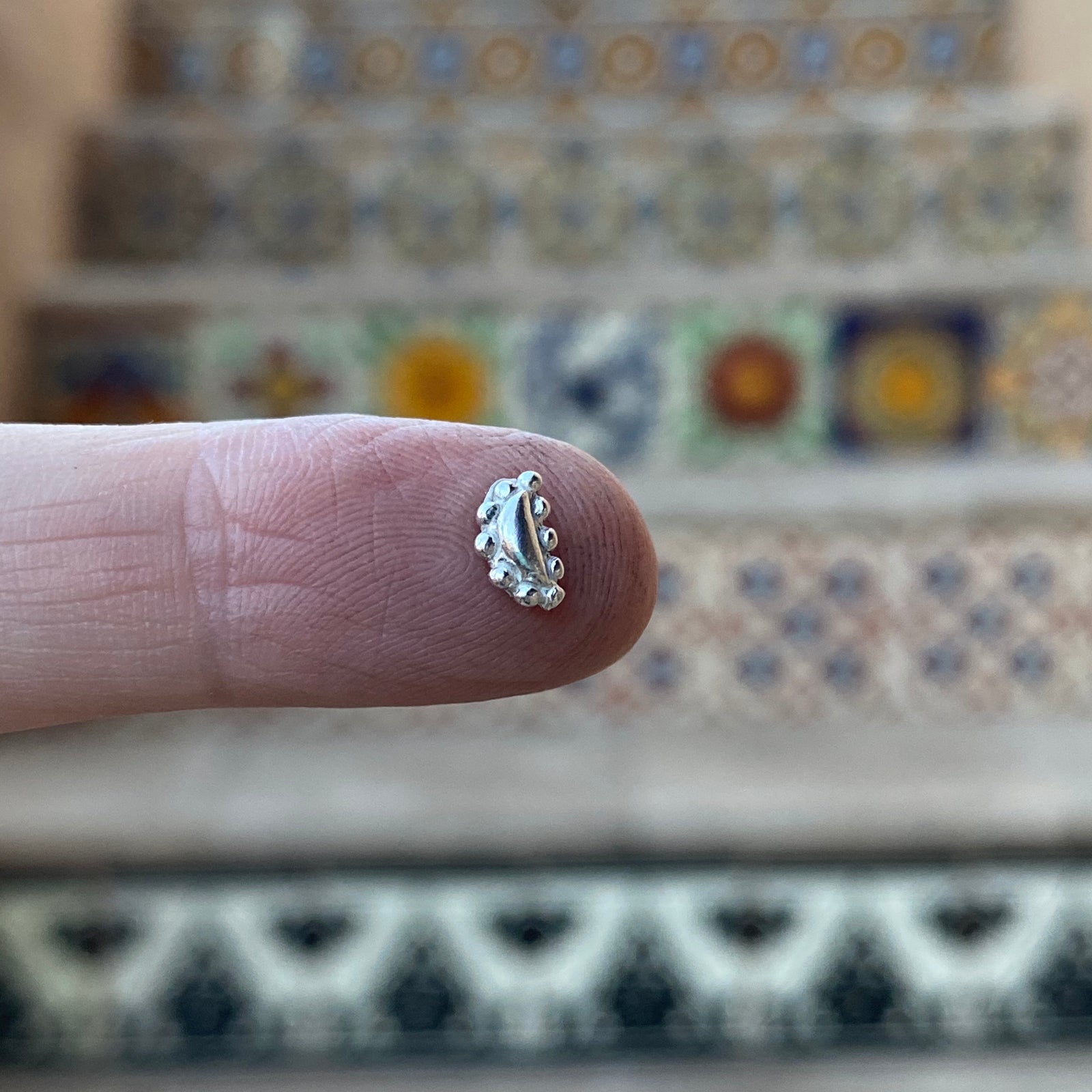 cast silver bead embellishment on finger
