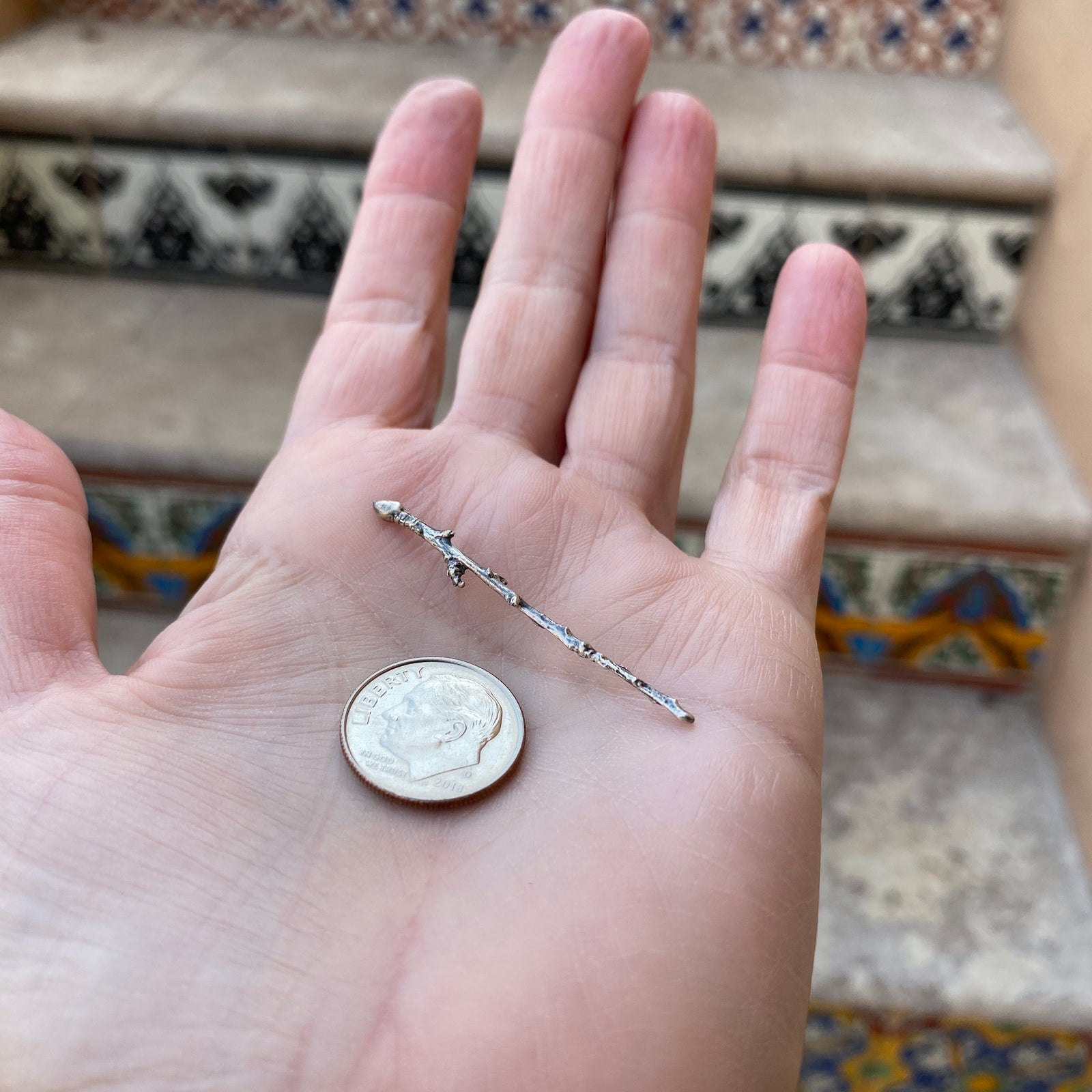 cast twig with dime for size reference